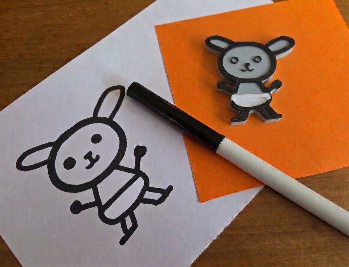 Sophie's felt-tip drawing of Booboo the bunny, beside the same bunny printed in 3D and coloured in